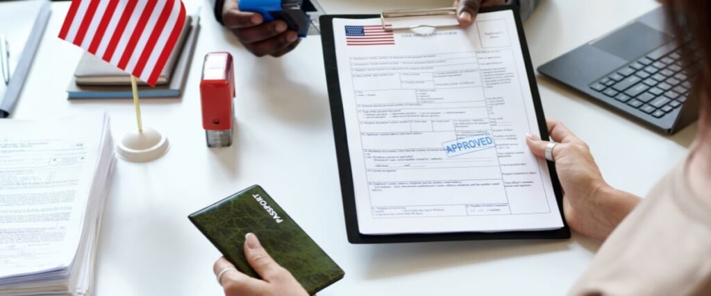 Close-up of L‑1A visa application and Nigerian founder’s passport, illustrating documentation requirements for petition.