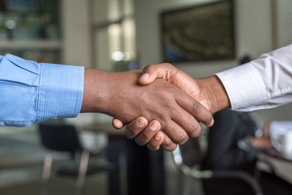 Two professionals shaking hands in an office setting
