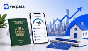 Green Nigerian passport, credit score on smartphone, and credit card on desk