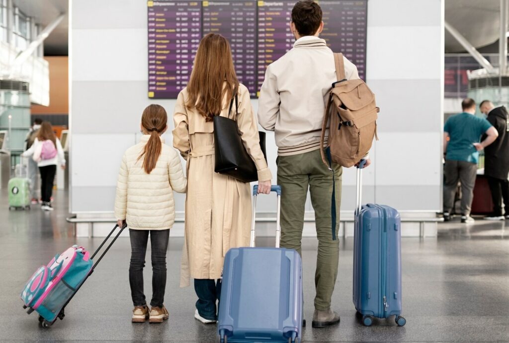 Parents and child with luggage at an airport, representing Nigerian families immigrating to the US.