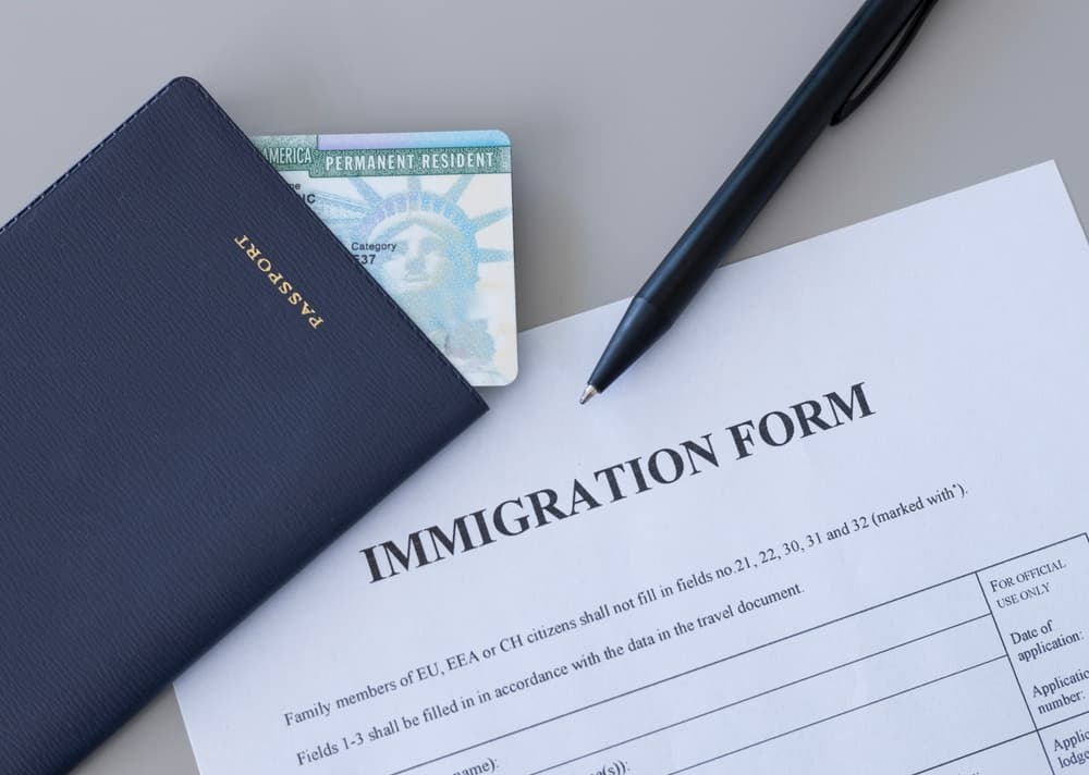  US immigration form with passport and green card
