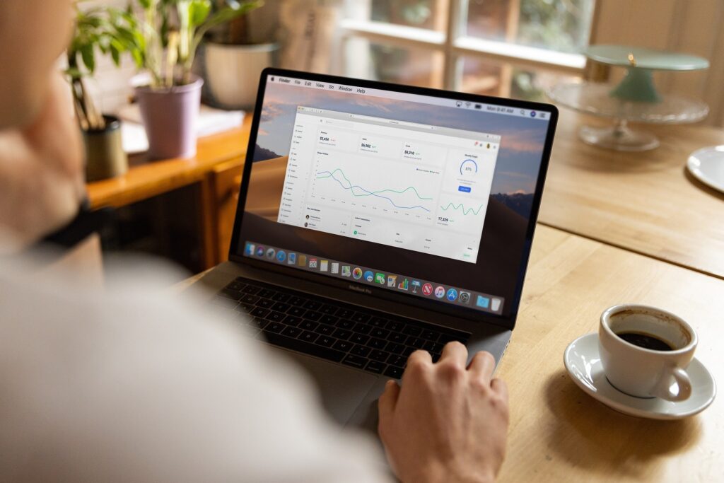 Person reviewing analytics dashboard on a laptop, representing the kind of documented data used as evidence in O-1B petitions.
