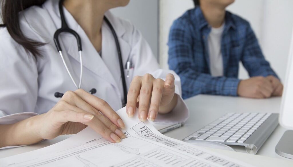Doctor reviewing the US immigration medical form with the patient.