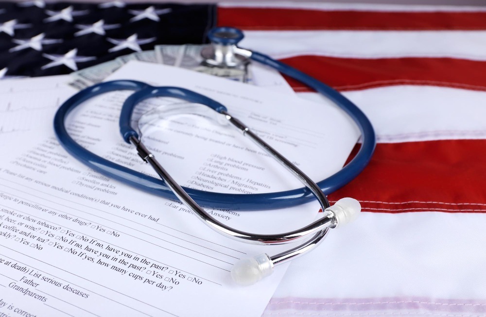 Stethoscope on US immigration medical form with American flag